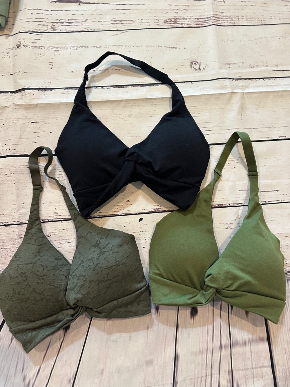 NVGTN Twist-Halter Bralettes Available in black, Olive, or a crackled green.